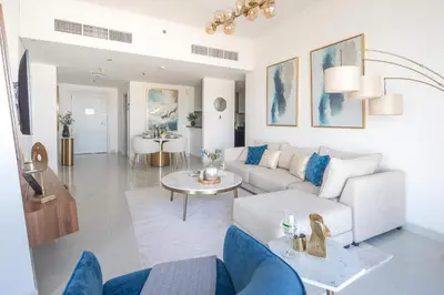 a living room with a couch and a table at Frank Porter - Damac Heights in Dubai