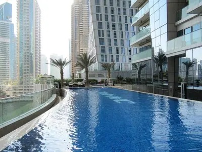 a large swimming pool in a city with tall buildings at Frank Porter - Damac Heights in Dubai