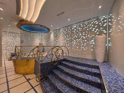 a room with a bench and a wall with lights at Frank Porter - Damac Heights in Dubai