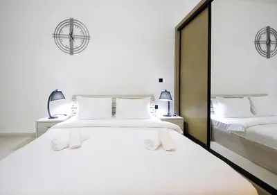 a bedroom with a large white bed and a mirror at Elegant Studio in Binghatti Canal, Downtown Access in Dubai