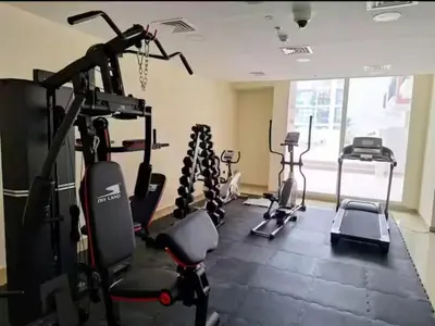 a gym with several tread machines in a room at Ayla Residence 1 in Dubai
