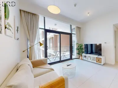 a living room with a couch and a tv at Chic 2 Bedroom Apartment - Park Point - Dubai Hills in Dubai