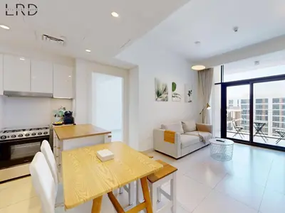 a kitchen and living room with a table and a dining room at Chic 2 Bedroom Apartment - Park Point - Dubai Hills in Dubai
