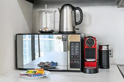a microwave sitting on a kitchen counter with at The Lofts East Unique 1BR Boulevard Views close to Dubai Mall in Dubai