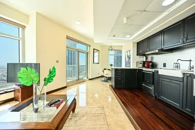 a kitchen with black cabinets and a table at The Lofts East Unique 1BR Boulevard Views close to Dubai Mall in Dubai