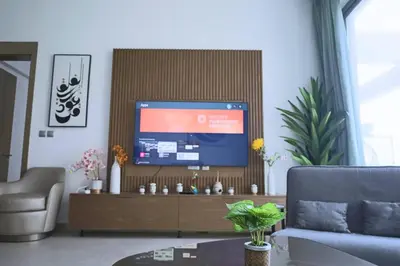 a living room with a couch and a television at Cozy 1BR Apt in Bluebell Residences,JVC in Dubai