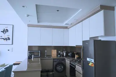 a kitchen with a black refrigerator and a dishwasher at Cozy 1BR Apt in Bluebell Residences,JVC in Dubai