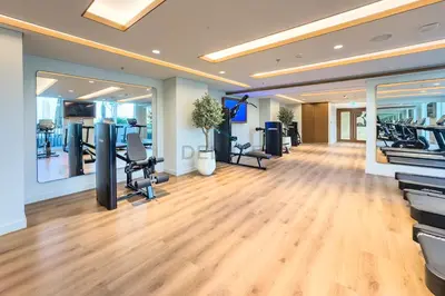 a gym with treadmills and exercise equipment in a room at Partial Marina and City Views 1BR, Close to JBR Beach, Palace Beach Residence Tower 2,Emaar Beachfront ,Dubai Marina by Deluxe Holiday Homes in Dubai