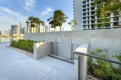a bench on a sidewalk in front of a building at Partial Marina and City Views 1BR, Close to JBR Beach, Palace Beach Residence Tower 2,Emaar Beachfront ,Dubai Marina by Deluxe Holiday Homes in Dubai