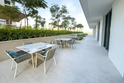 a row of tables and chairs on a patio at Partial Marina and City Views 1BR, Close to JBR Beach, Palace Beach Residence Tower 2,Emaar Beachfront ,Dubai Marina by Deluxe Holiday Homes in Dubai