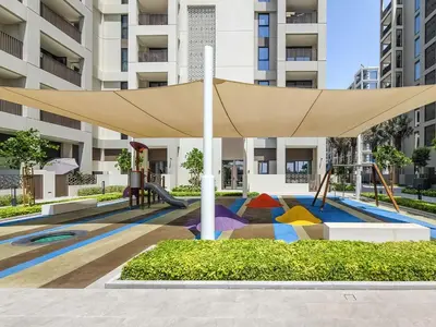 a playground with a canopy in front of a building at Bright and Stylish 2BD at Creek Beach, Sleeps 4 in Dubai