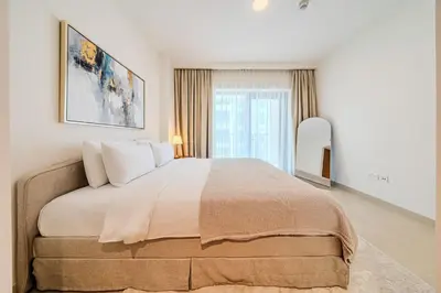 a bedroom with a large bed and a large window at Bright and Stylish 2BD at Creek Beach, Sleeps 4 in Dubai