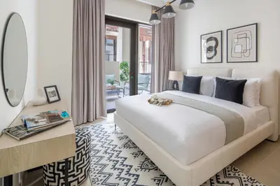 a bedroom with a large bed and a mirror at Frank Porter - Groove 1 at Creek Beach in Dubai