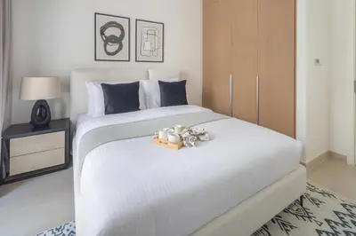 a bedroom with a white bed with teddy bears on it at Frank Porter - Groove 1 at Creek Beach in Dubai