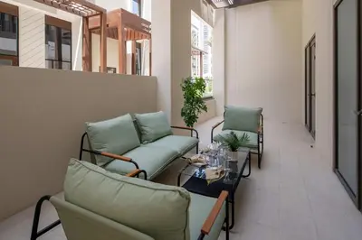 a balcony with two chairs and a table in a building at Frank Porter - Groove 1 at Creek Beach in Dubai