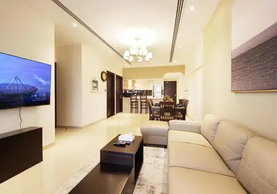 a living room with a white couch and a table at 2BR Stylish Elite Apartment Near Burj Khalifa in Dubai