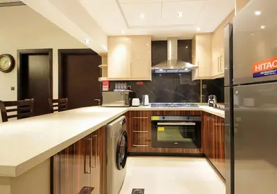 a kitchen with a stove and a dishwasher at 2BR Stylish Elite Apartment Near Burj Khalifa in Dubai