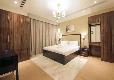 a bedroom with a bed and a desk in it at 2BR Stylish Elite Apartment Near Burj Khalifa in Dubai