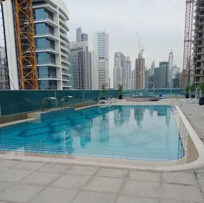 a large swimming pool in the middle of a city at 2BR Stylish Elite Apartment Near Burj Khalifa in Dubai