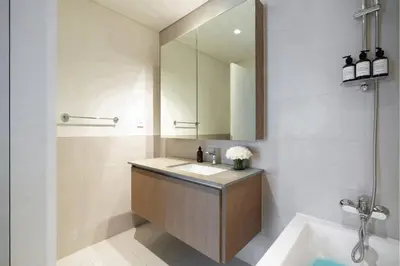 a bathroom with a sink and a mirror at Luxury Apt and Private Beach with cooled sand in Dubai