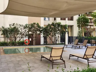 a patio with chairs and a pool in a building at Luxury Apt and Private Beach with cooled sand in Dubai