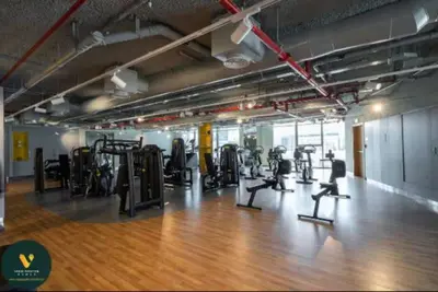 a gym with treadmills and cardio equipment in a room at Vogue Downtown Views II with Direct Access to Dubai Mall Via a Climate Controlled Bridge, One Bedroom Apartment with Balcony and City View in Dubai