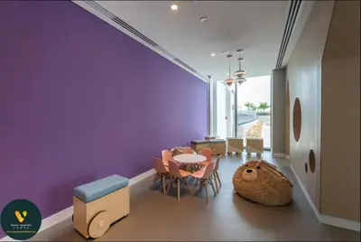 a dining room with purple walls and a table and chairs at Vogue Downtown Views II with Direct Access to Dubai Mall Via a Climate Controlled Bridge, One Bedroom Apartment with Balcony and City View in Dubai