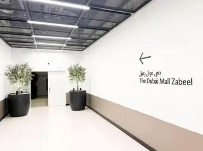 a hallway with two potted plants in a building at Vogue Downtown Views II with Direct Access to Dubai Mall Via a Climate Controlled Bridge, One Bedroom Apartment with Balcony and City View in Dubai