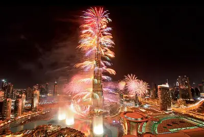 a fireworks display in front of a city at night at Vogue Downtown Views II with Direct Access to Dubai Mall Via a Climate Controlled Bridge, One Bedroom Apartment with Balcony and City View in Dubai