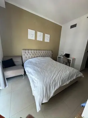 a bedroom with a large bed and a couch at Holidays home in Dubai
