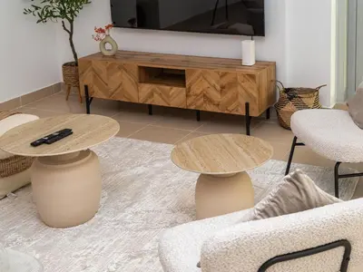 a living room with two tables and a tv at Burj Views 3 min from Dubai Mall Luxury DownTown Residence in Dubai