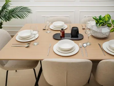 a wooden table with plates and wine glasses on it at Burj Views 3 min from Dubai Mall Luxury DownTown Residence in Dubai