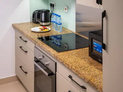 a kitchen with a counter top with a microwave at Burj Views 3 min from Dubai Mall Luxury DownTown Residence in Dubai