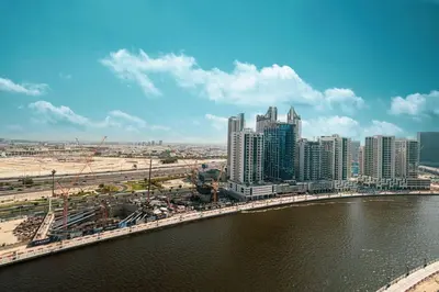 a city with tall buildings next to a river at New Studio in Business Bay with private Jacuzzi in Dubai