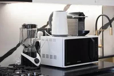 a blender sitting on a counter next to a microwave at New Studio in Business Bay with private Jacuzzi in Dubai