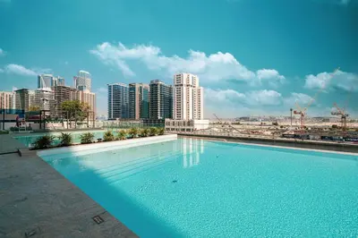 a large swimming pool with a city in the background at New Studio in Business Bay with private Jacuzzi in Dubai