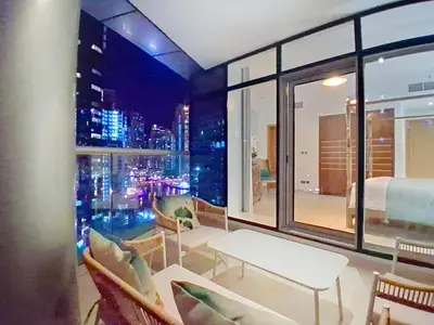 a room with a view of a city at night at Trident Bayside - Beautiful Two Bed in the Marina in Dubai