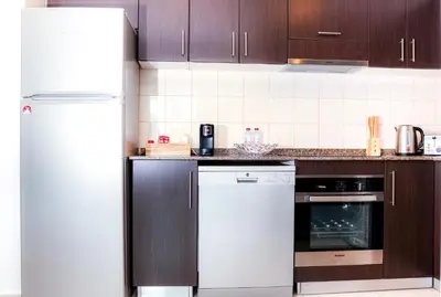 a kitchen with a white refrigerator and a dishwasher at Full Marina view, mins to JBR beach, Ain Dubai, Palm in Dubai