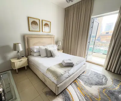a bedroom with a bed and a large window at Full Marina view, mins to JBR beach, Ain Dubai, Palm in Dubai