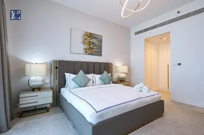 a bedroom with a large bed and two lamps at Luxury Escapes - Exquisite 3BR plus Maid, Full Sea View in JBR in Dubai