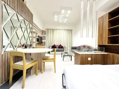 a hotel room with a bed and a table and chairs at 1Bedroom Apartment with Portable bed in Living Area in Dubai