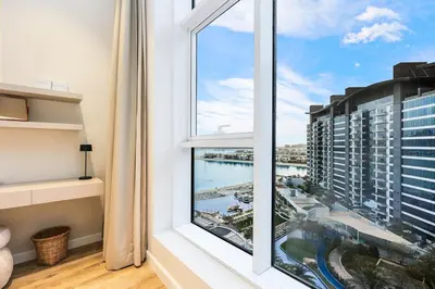 a room with a window with a view of a city at Family Beach Home 3BR on Palm Jumeirah with Pool in Dubai