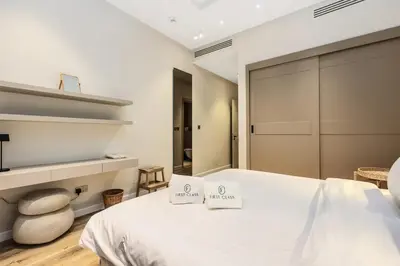 a bedroom with a white bed with two signs on it at Family Beach Home 3BR on Palm Jumeirah with Pool in Dubai