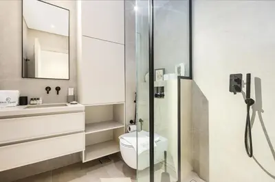 a bathroom with a toilet and a sink and a shower at Family Beach Home 3BR on Palm Jumeirah with Pool in Dubai