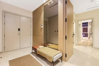 a dressing room with a bench and a mirror at Family Beach Home 3BR on Palm Jumeirah with Pool in Dubai