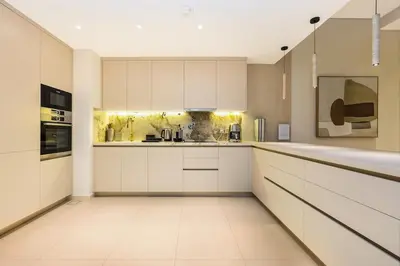 a white kitchen with white cabinets and appliances at Family Beach Home 3BR on Palm Jumeirah with Pool in Dubai