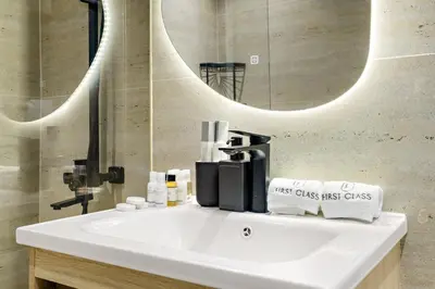 a bathroom with a white sink and a mirror at Dubai Marina Luxury 2BR with Pool, Gym & Near JBR Beach, Metro in Dubai