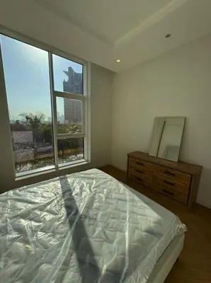a bedroom with a bed and a dresser and a window at 5 Star Luxury 3BR Apartment on The Palm with Huge Pool and Beach in Dubai