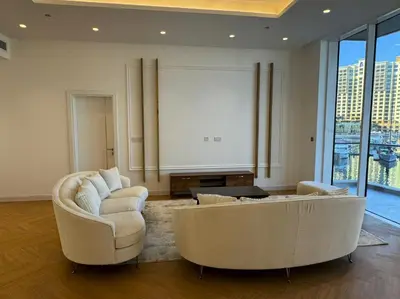a living room with two couches and a large window at 5 Star Luxury 3BR Apartment on The Palm with Huge Pool and Beach in Dubai