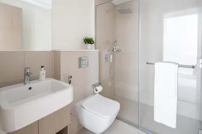 a bathroom with a sink and a toilet and a shower at Frank Porter - Murooj Al Furjan West in Dubai